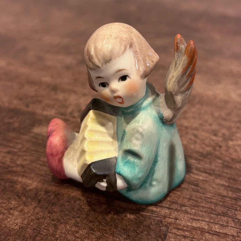This is a vintage Goebel Hummel Angel with
Accordion porcelain figurine.